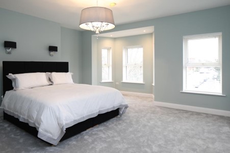 Master bedroom in Drumcondra residence with statement centre light and reader wall lights