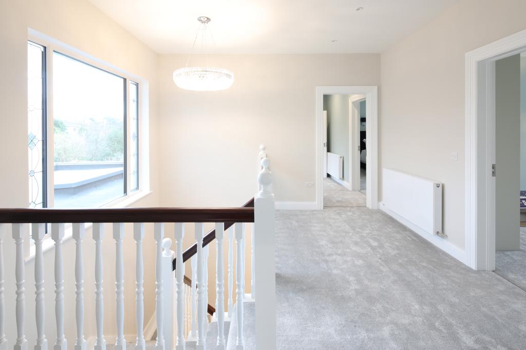 Bright upstairs landing with contemporary crystal pendant and recessed spotlights