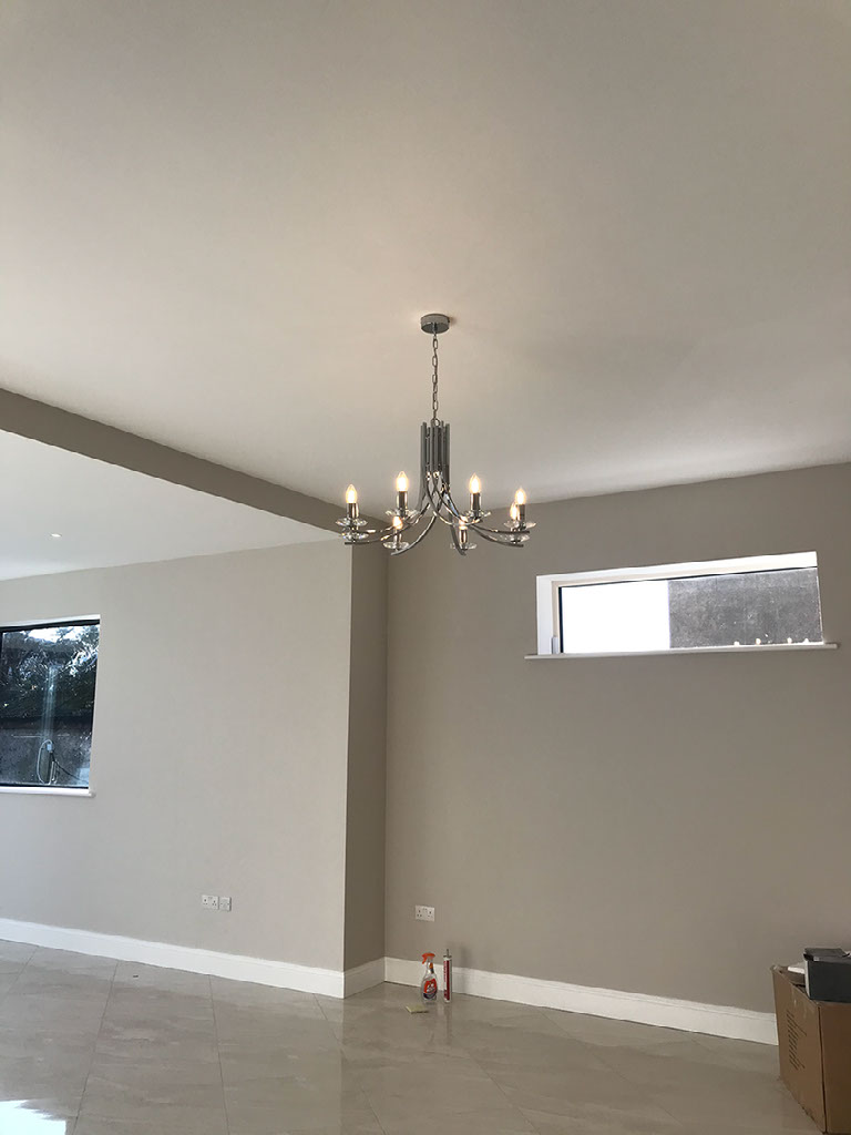 Dining room in Drumcondra residence with chrome contemporary eight light chandelier