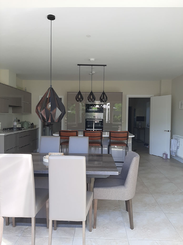 Modern Mayo new build kitchen and dining room with black and copper pendants