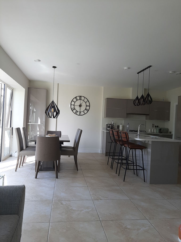 Bright open-plan kitchen and dining area in Mayo with contemporary pendant lighting
