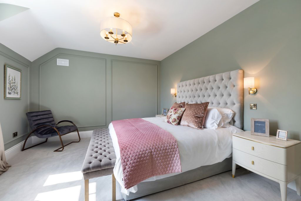 Showhome bedroom with antique brass centre light and neutral white shade